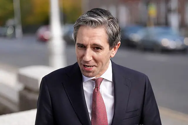 Taoiseach Simon Harris speaking to members of the media outside Government Building in Dublin