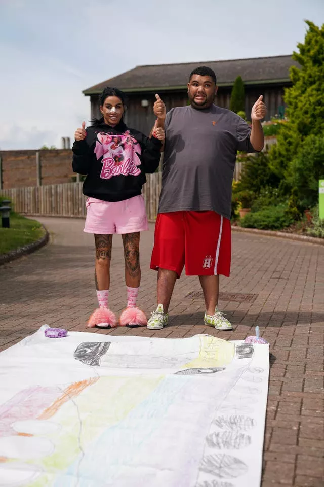 Katie Price and her son Harvey stand by his 21.3 metre drawing, which has set a new Guinness World Record (Jacob King/PA)