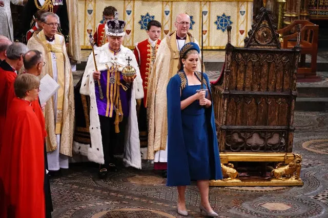 Lord President of the Council, Penny Mordaunt, holding the Sword of State walking ahead of King Charles III during his coronation ceremony