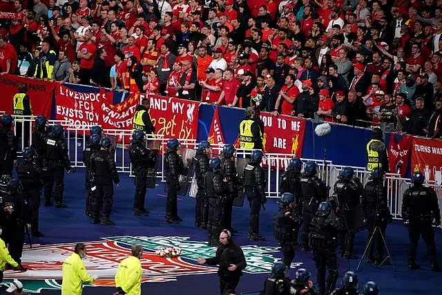 Police stand in front of Liverpool fans during the Champions League final at the Stade de France