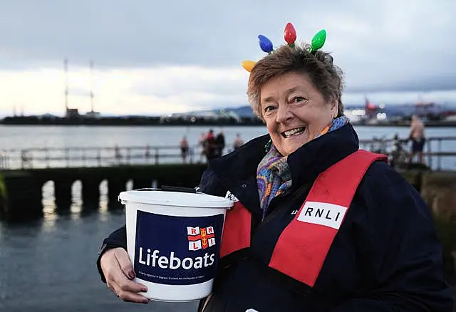 A woman with an RNLI collection bucket