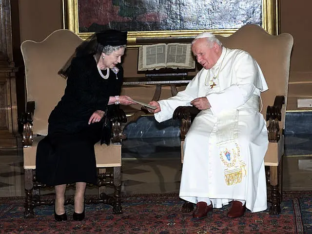 Queen Elizabeth II exchanging letters with Pope John Paul II during an audience at the Vatican in Rome in 2000