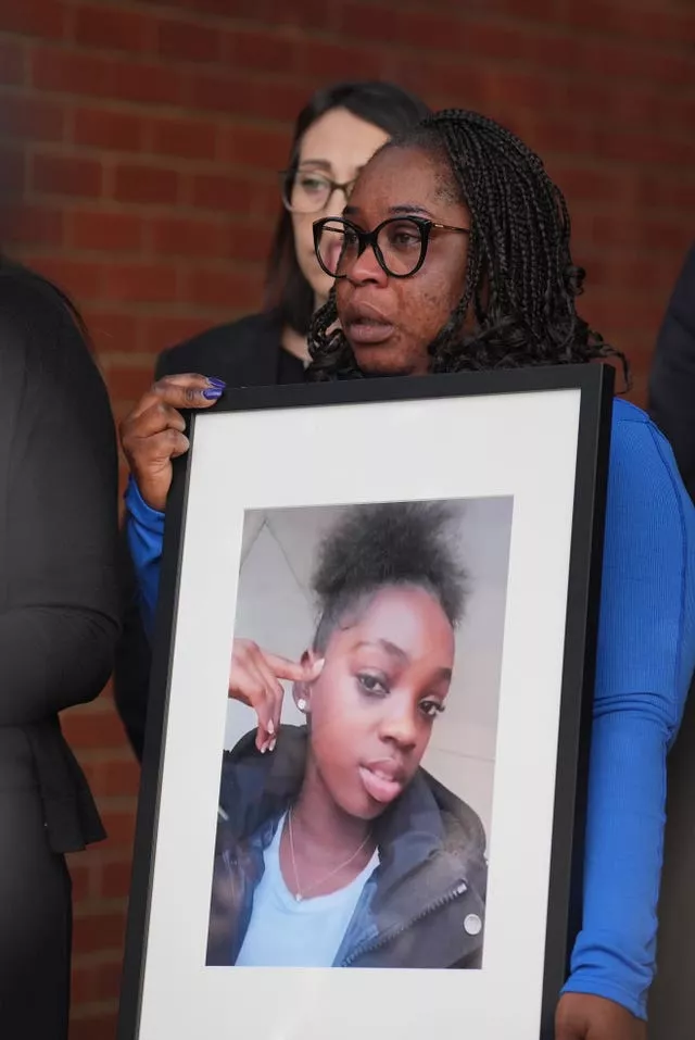 Hannah’s mother, Abimbola Duyile, holds a picture of her daughter outside East London Coroner’s Court 