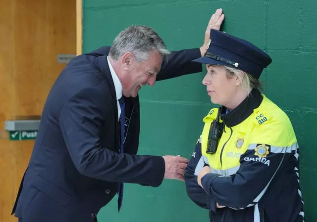 Billy Kelleher speaks to a member of An Garda Siochana as he awaits election count results