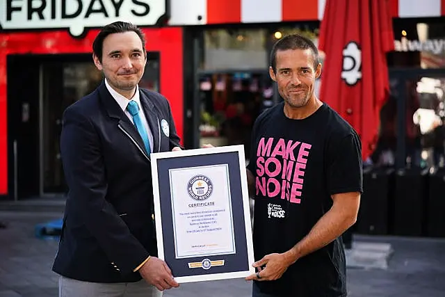 Guinness World Record adjudicator Will Munford presents Matthews with his Guinness World Record certificate 