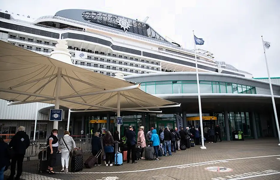 People line up outside the departure lounge 