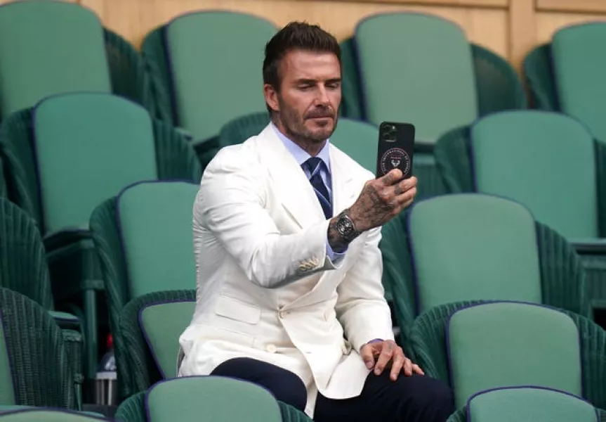 David Beckham takes a photo 