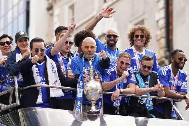 Enzo Maresca, holding trophy, guided Leicester straight back to the Premier League last season