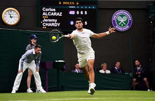 Carlos Alcaraz hits a forehand on his way to victory