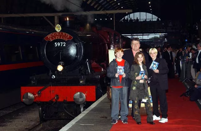 Actors Robbie Coltrane (rear), and (from left) Rupert Grint Emma Watson and Warwick Davis at Kingscross Station, central London, for the Harry Potter & The Philosopher’s Stone – DVD & video launch party on May 8 2002