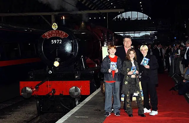 Actors Robbie Coltrane (rear), and (from left) Rupert Grint Emma Watson and Warwick Davis at Kingscross Station, central London, for the Harry Potter & The Philosopher’s Stone – DVD & video launch party on May 8 2002