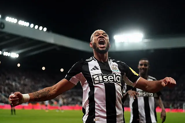 Joelinton celebrates scoring by throwing his arms out