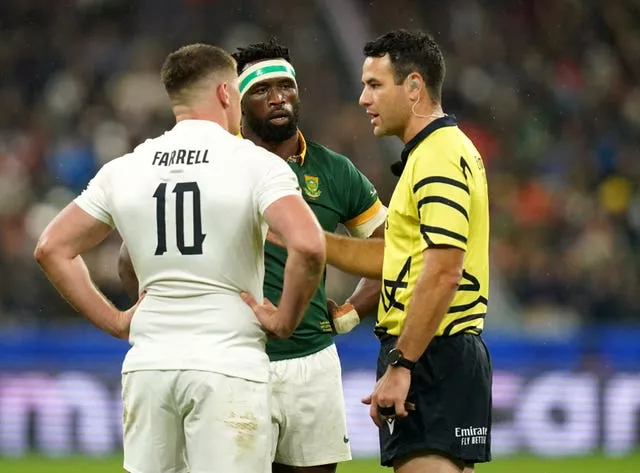 Referee Ben O'Keeffe, right, speaks to England and South Africa captains Owen Farrell, left, and Siya Kolisi, centre
