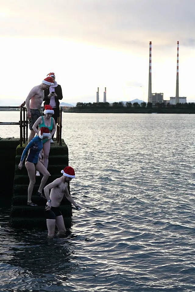 People descend steps into the sea 