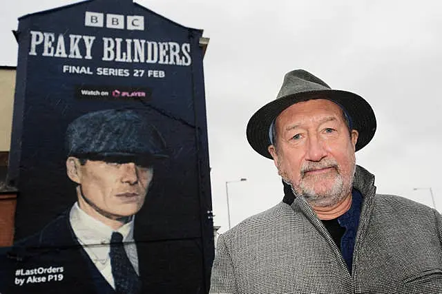 Steven Knight in front of a Peaky Blinders mural