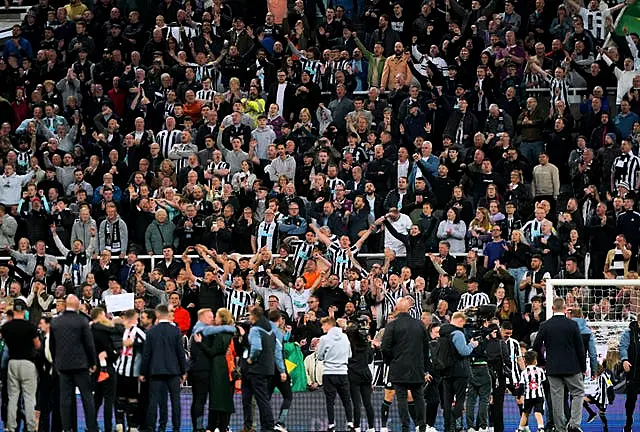 Newcastle fans celebrate at the end of the game 