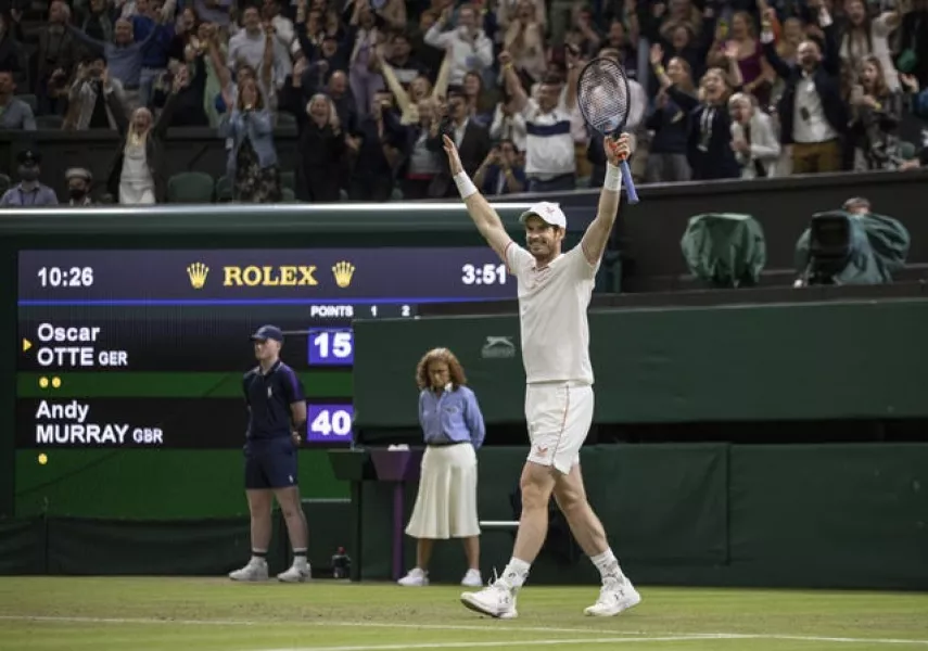 Andy Murray raises his arms to the Centre Court crowd after battling past Oscar Otte