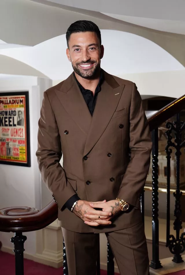 Dancer Giovanni Penice wearing a brown suit