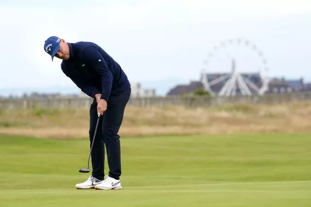 Alex Noren putts on the first green