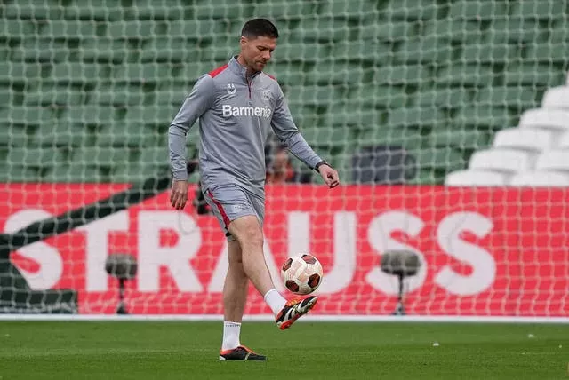 Bayer Leverkusen manager Xabi Alonso kicks a ball in training