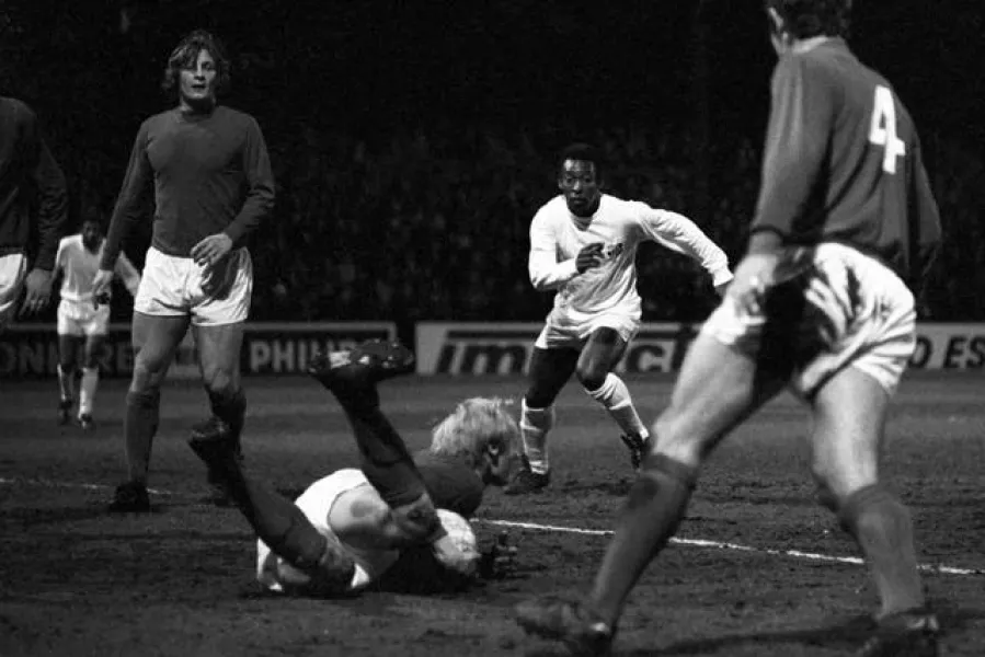 Fulham goalkeeper Peter Mellor dives at the feet of Pele to smother the ball 