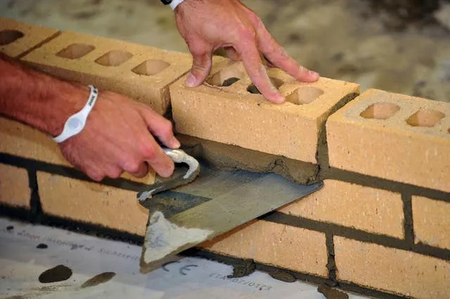 A bricklayer at work (Ian Nicholson/PA)