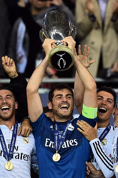 Iker Casillas, centre, lifts the UEFA Super Cup in 2014, flanked by Real Madrid team-mates Cristiano Ronaldo, right, and Sergio Ramos
