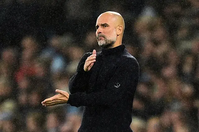 Pep Guardiola swipes one hand across the other in frustration during Manchester City's 4-0 defeat to Tottenham