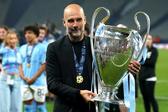 Manchester City manager Pep Guardiola holds the Champions League trophy after his side's 2023 final triumph