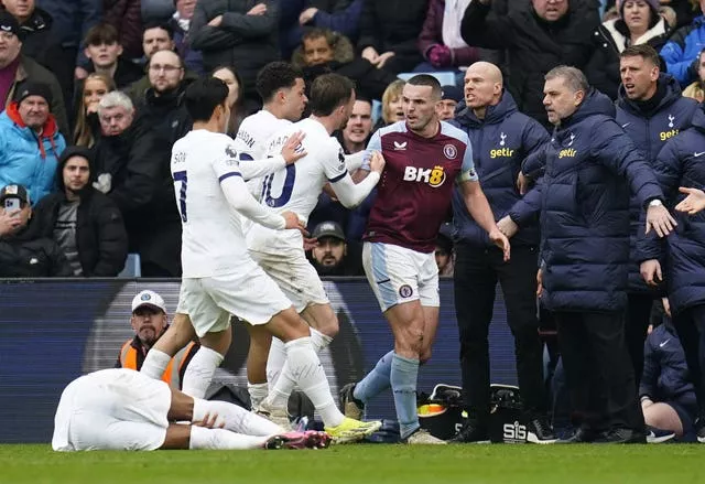 Aston Villa's John McGinn, right, is confronted by Tottenham's Son Heung-min, Brennan Johnson and James Maddison, from left, as Destiny Udogie lies on the ground