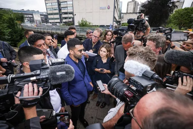 A lawyer surrounded by media