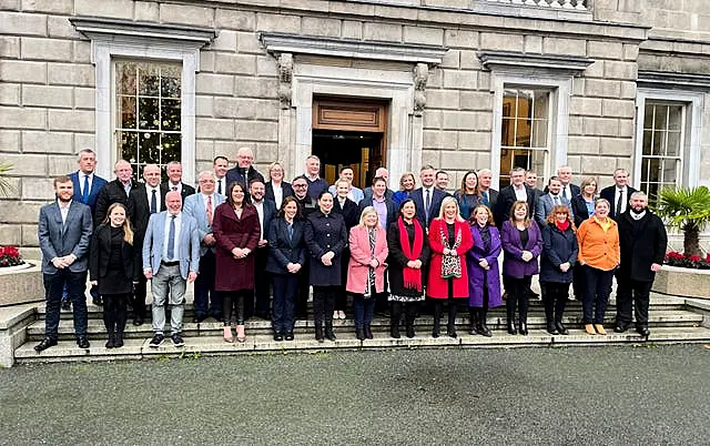 Mary Lou McDonald and Michelle O’Neill with Sinn Fein’s TDs outside Leinster House in Dublin