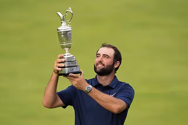 Scottie Scheffler lifts the trophy after winning the 2025 Open