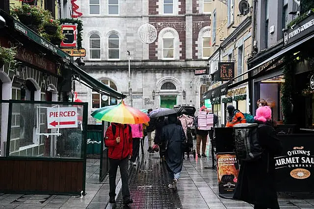 People walk through Cork city centre ahead of the General Election on Friday