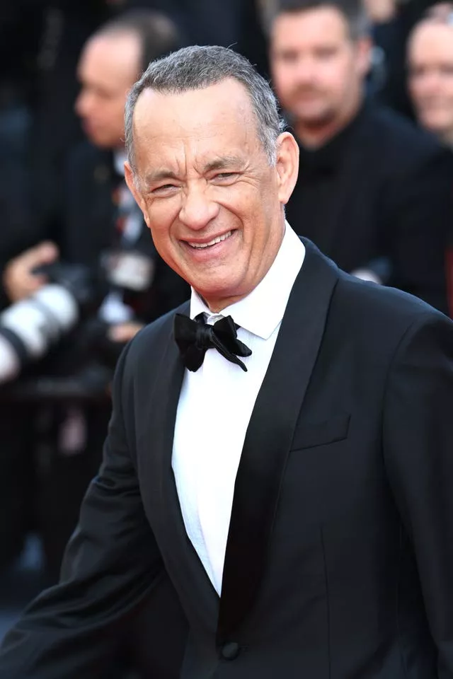 Tom Hanks smiling in a tuxedo