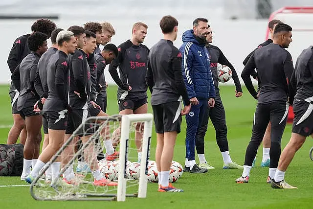 Manchester United interim manager Ruud van Nistelrooy surrounded by players during training