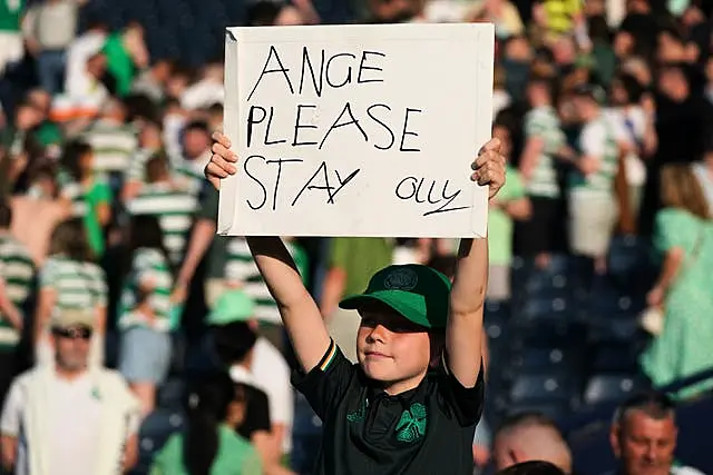 A young Celtic fan holds up a sign at Hampden on Saturday