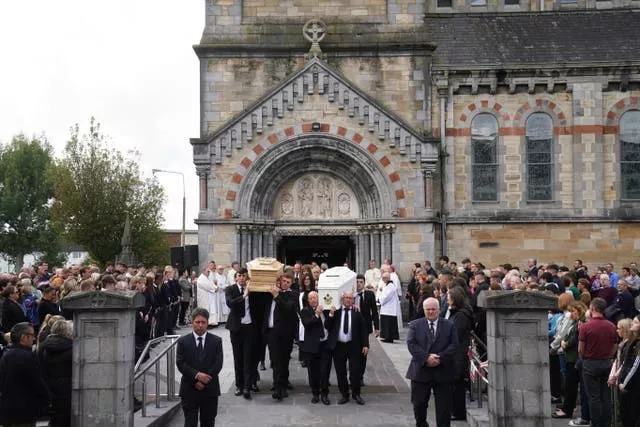 The coffins of siblings Luke and Grace McSweeney are carried out following their funeral at Saints Peter and Paul’s Church, Clonmel, Co Tipperary