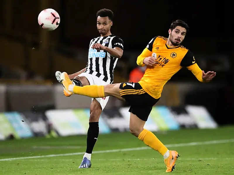 Jacob Murphy, left, and Wolves’ Pedro Neto battle for the ball