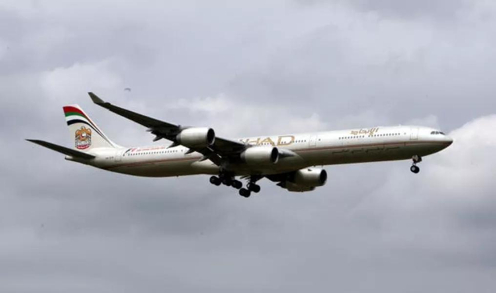 An Etihad Airbus A340 plane lands at Heathrow Airport in Middlesex (Steve Parsons/PA)