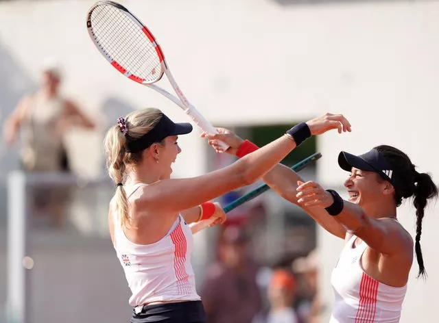 Katie Boulter, left, and Heather Watson hug after winning in Paris