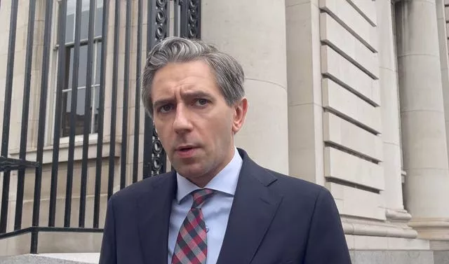 Taoiseach Simon Harris speaking to the media outside Government Buildings in Dublin