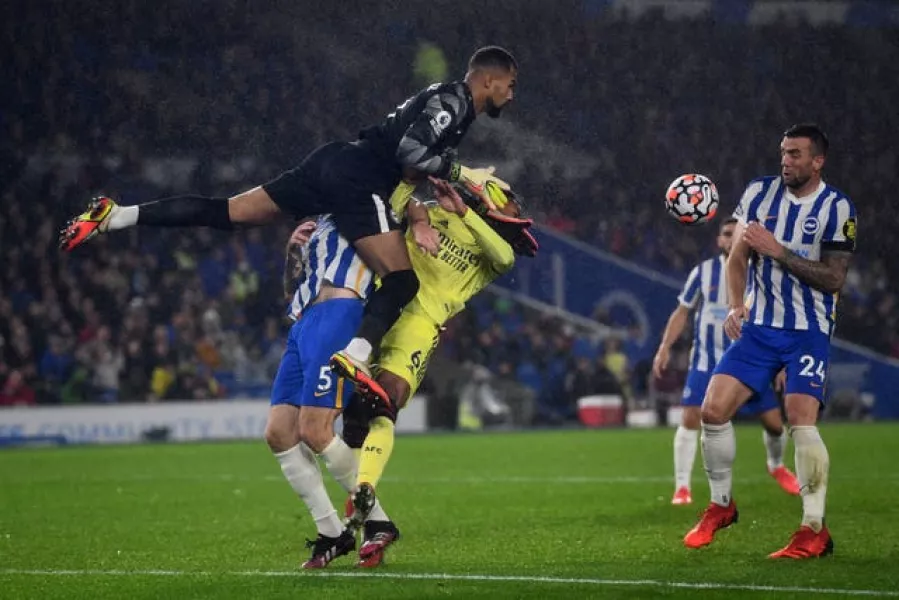 Brighton goalkeeper Robert Sanchez, left, collides with team-mate Lewis Dunk and Arsenal’s Gabriel Magalhaes