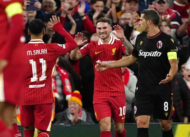 Alexis Mac Allister gives Mohamed Salah a high five after scoring