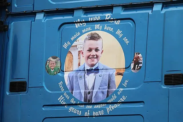 Images on the back of a haulage lorry that carried the coffin of Ronan Wilson