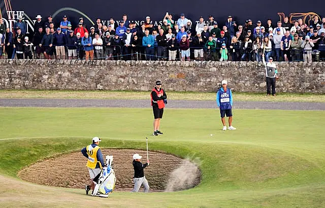 Xander Schauffele blasts out of a bunker 