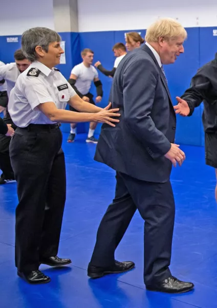 Prime Minister Boris Johnson being steadied by Police Commissioner Cressida Dick as he observes a self-defence class during a visit to Metropolitan Police training college in Hendon, north London (Aaron Chown/PA)