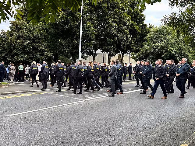 A Garda guard of honour as the coffin of Detective Garda Deirdre (Dee) Finn is carried into St John the Evangelist church in Ballinteer, Co Dublin