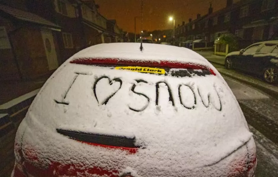 A message written on a car window coverd in snow