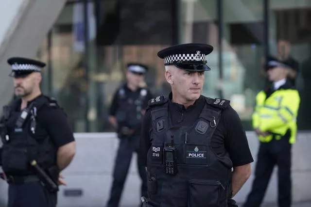 Police officers outside Liverpool Magistrates’ Court where the 17-year-old defendant is appearing